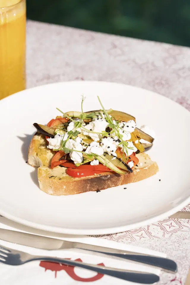 Vegetable and feta bruschetta served by the water
